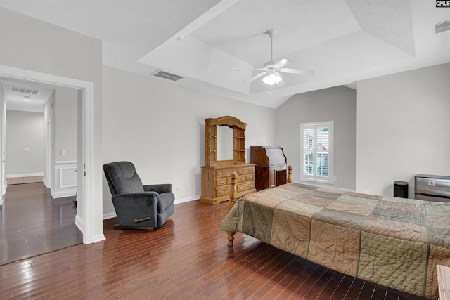 bedroom featuring ceiling fan, dark hardwood / wood-style flooring, a raised ceiling, and vaulted ceiling