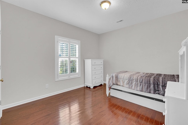 bedroom with hardwood / wood-style floors