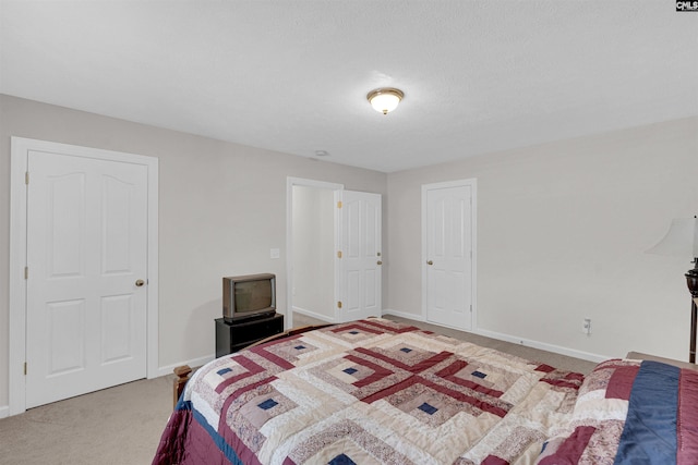 bedroom with a textured ceiling and carpet flooring