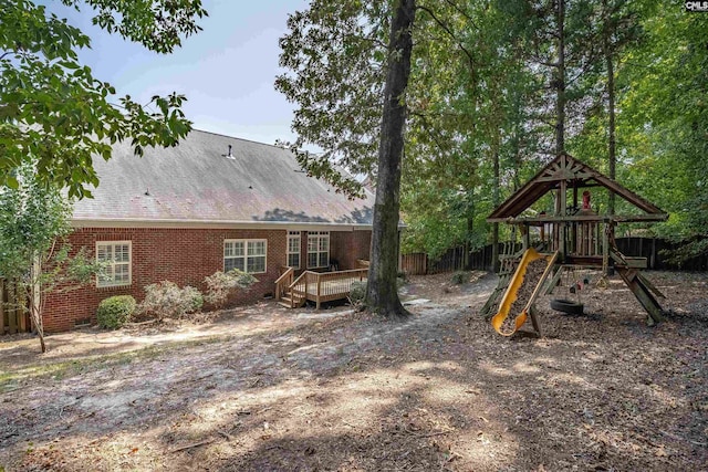 exterior space featuring a playground and a deck