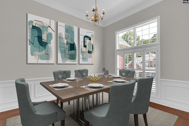 dining area with ornamental molding, dark wood-type flooring, and a notable chandelier