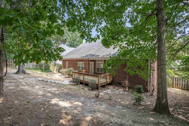 rear view of property with a wooden deck