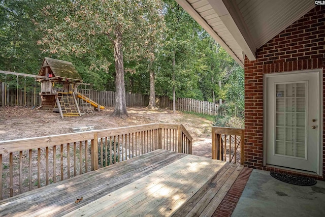 wooden terrace featuring a playground