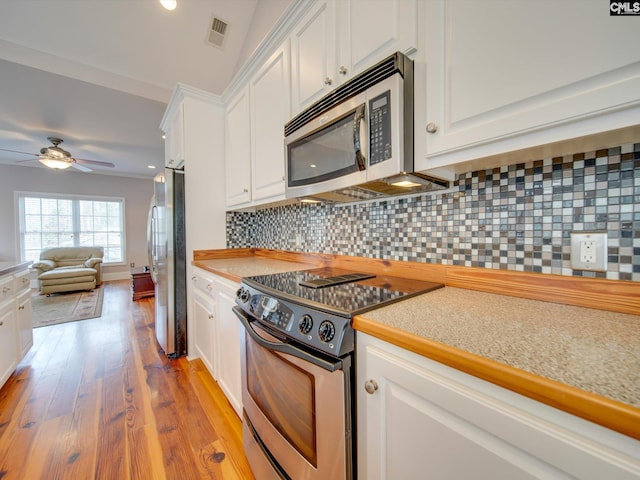 kitchen with ceiling fan, backsplash, stainless steel appliances, light hardwood / wood-style floors, and white cabinets