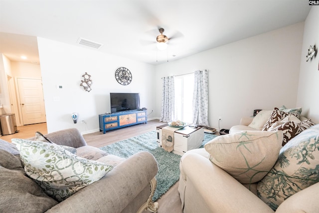 living room with ceiling fan and light wood-type flooring