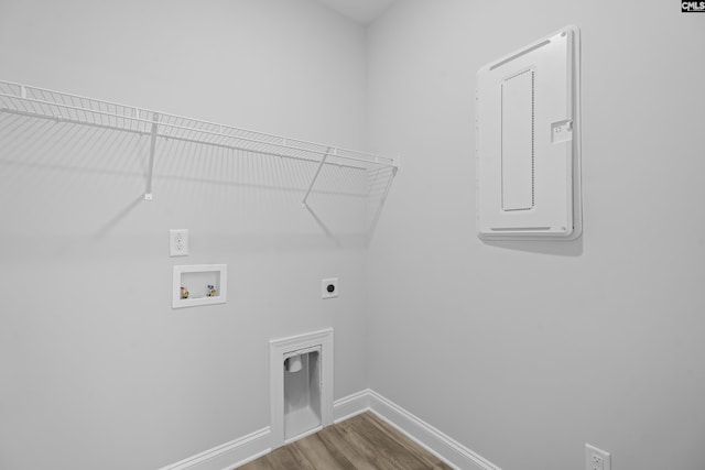 clothes washing area with hookup for a washing machine, hardwood / wood-style floors, and electric dryer hookup