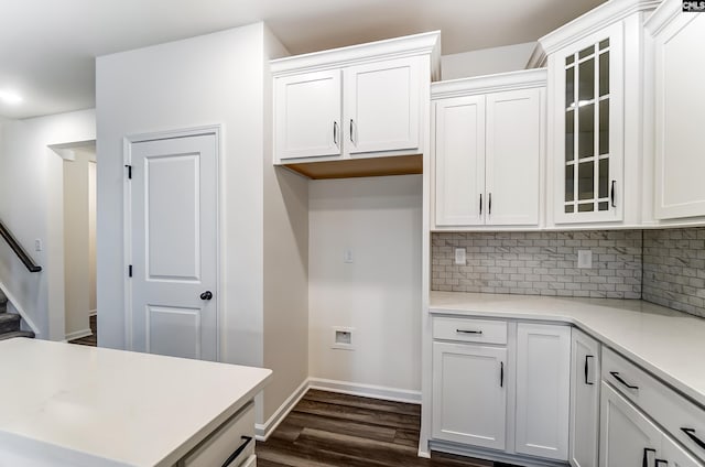 kitchen featuring tasteful backsplash, white cabinets, and dark hardwood / wood-style flooring