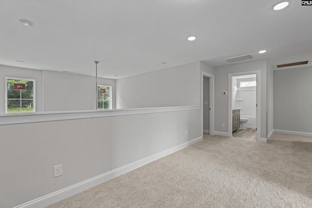 empty room featuring light colored carpet