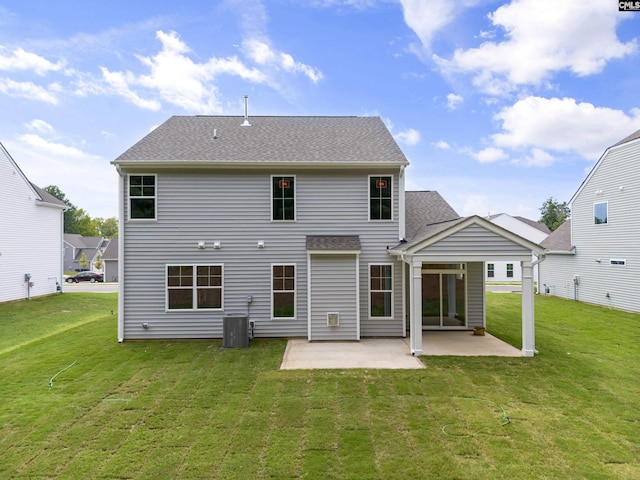 rear view of property with cooling unit, a lawn, and a patio