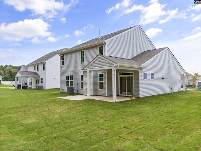 back of house featuring a yard, central AC unit, and a patio