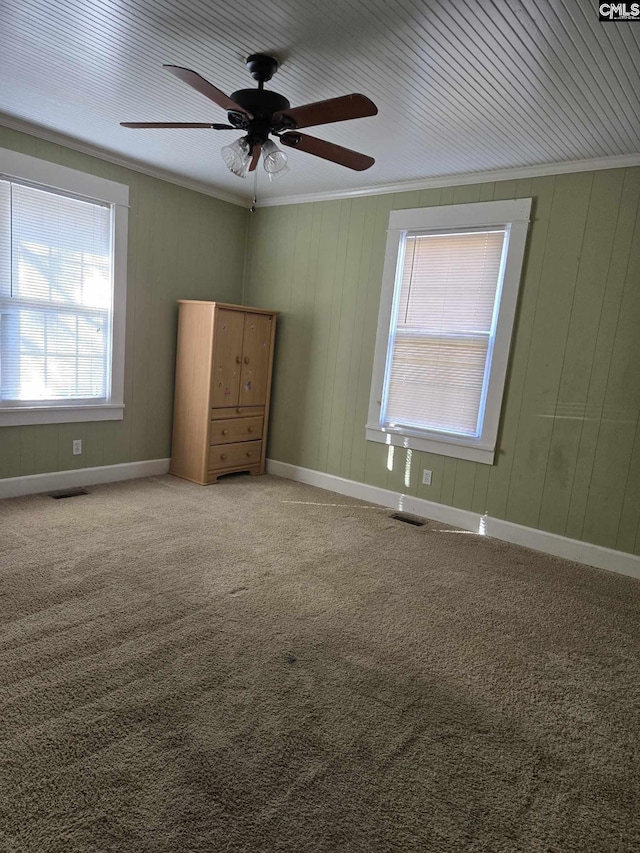 unfurnished bedroom featuring crown molding, carpet, and ceiling fan