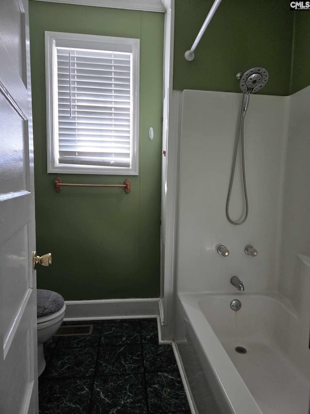 bathroom with shower / bath combination and toilet