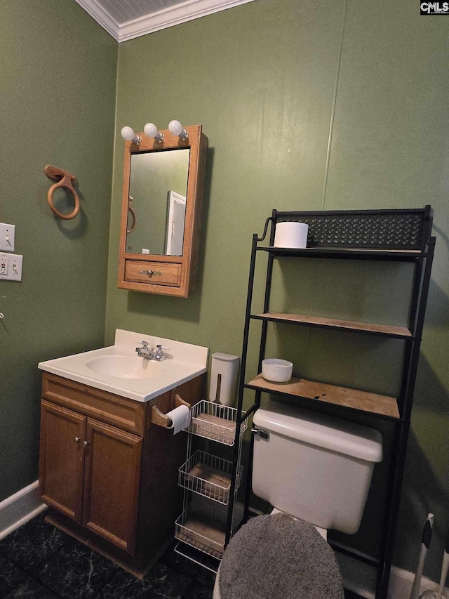 bathroom featuring vanity, crown molding, and toilet