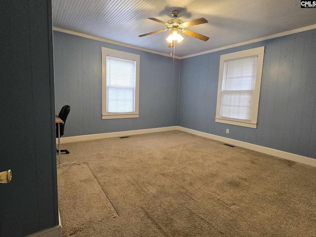 unfurnished room featuring crown molding, ceiling fan, and carpet flooring