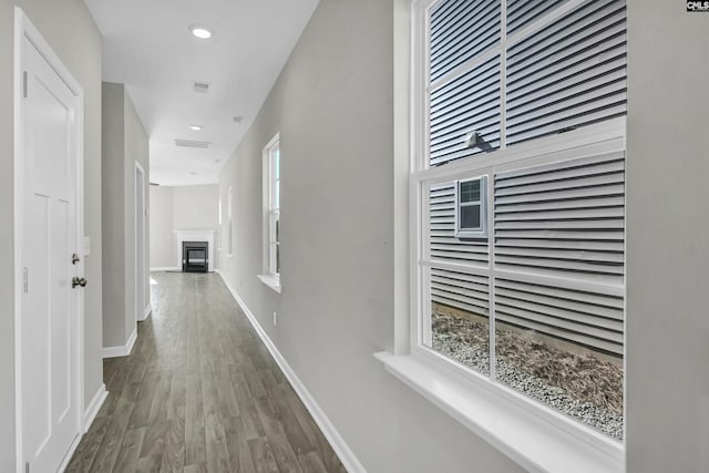 corridor with hardwood / wood-style floors