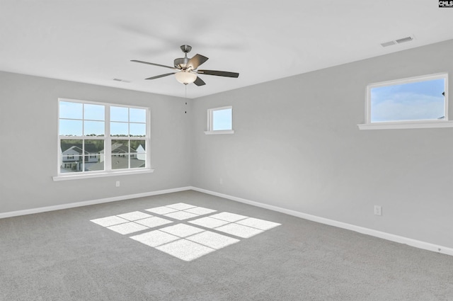 carpeted empty room featuring ceiling fan