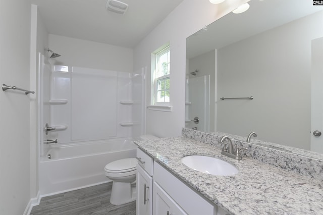 full bathroom with hardwood / wood-style flooring, vanity, toilet, and shower / bathing tub combination