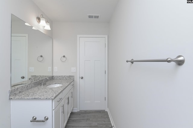 bathroom with hardwood / wood-style flooring and vanity