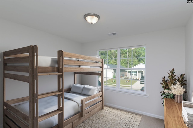 bedroom featuring light colored carpet