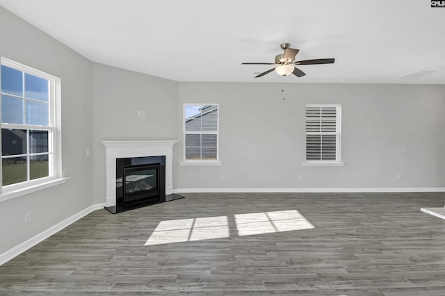 unfurnished living room featuring hardwood / wood-style flooring and ceiling fan