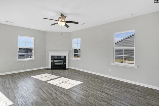 unfurnished living room with dark wood-type flooring and ceiling fan