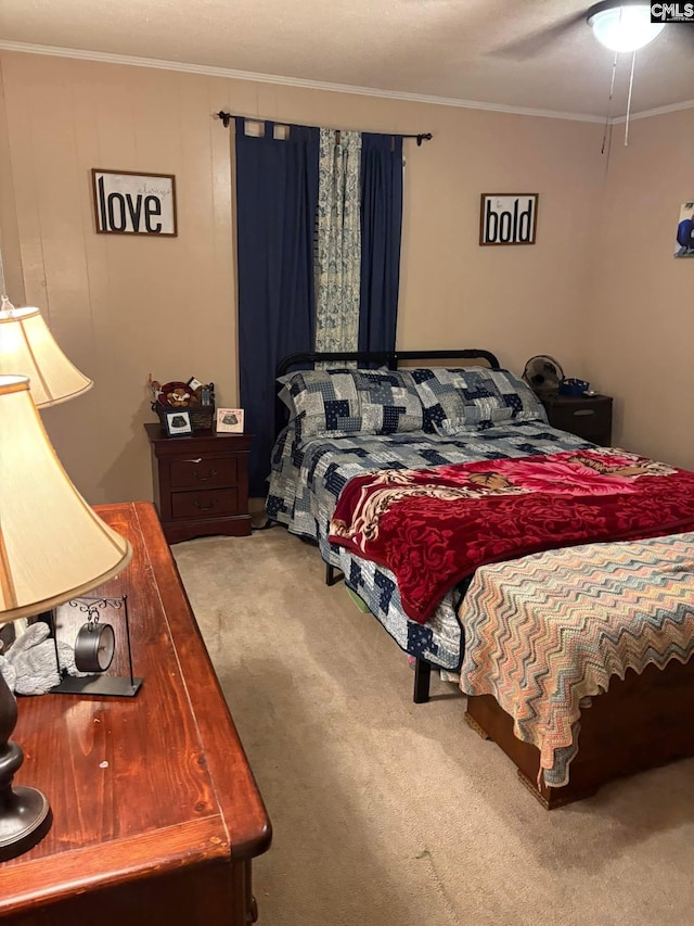 carpeted bedroom with crown molding and ceiling fan