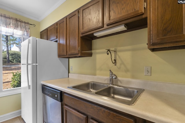 kitchen featuring sink, plenty of natural light, ornamental molding, and dishwasher