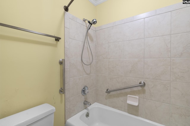 bathroom featuring tiled shower / bath and toilet