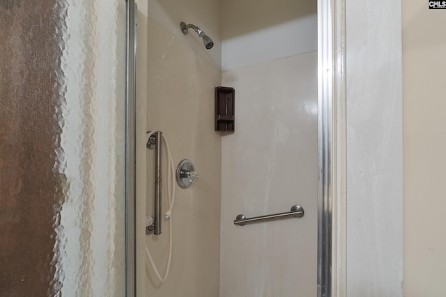 bathroom with a shower with door