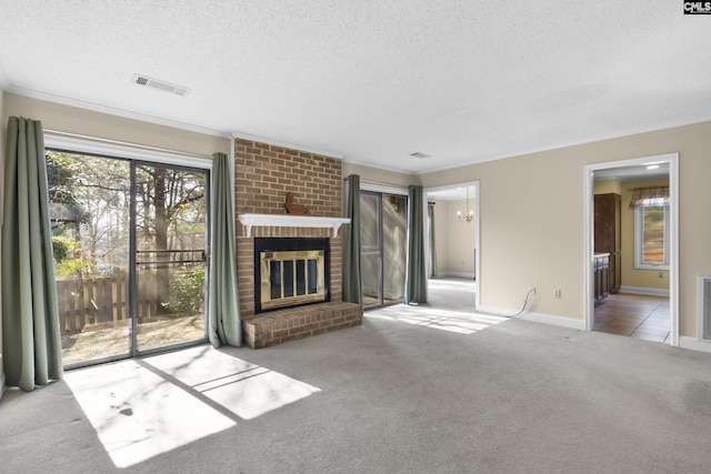 unfurnished living room with crown molding, a brick fireplace, light carpet, and a textured ceiling