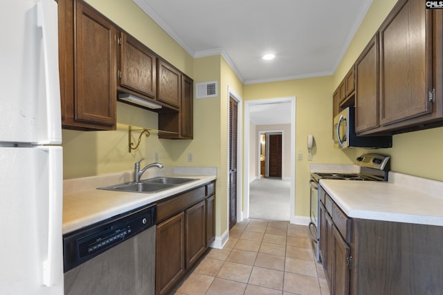 kitchen with light tile patterned flooring, sink, ornamental molding, dark brown cabinetry, and stainless steel appliances