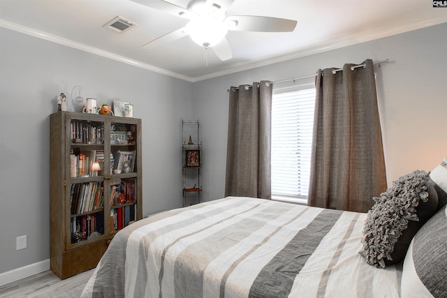 bedroom featuring crown molding, ceiling fan, and light hardwood / wood-style floors