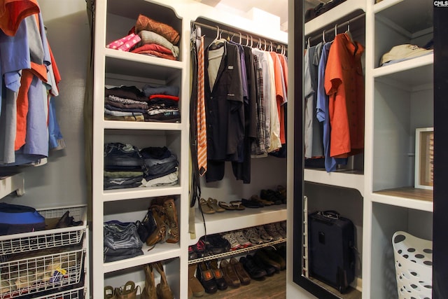 walk in closet with hardwood / wood-style floors