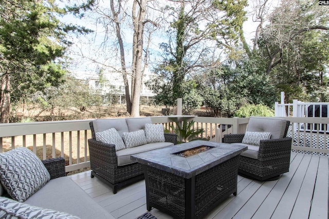 wooden terrace with an outdoor living space with a fire pit