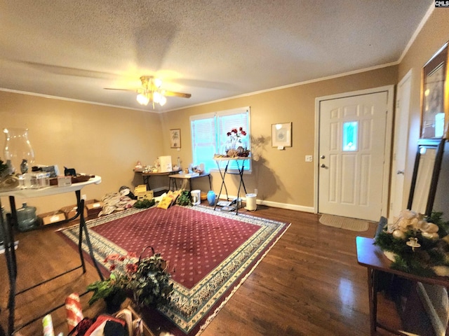 interior space with ceiling fan, crown molding, dark wood-type flooring, and a textured ceiling