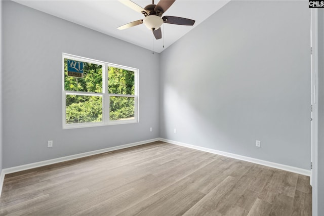 empty room with ceiling fan and light hardwood / wood-style flooring