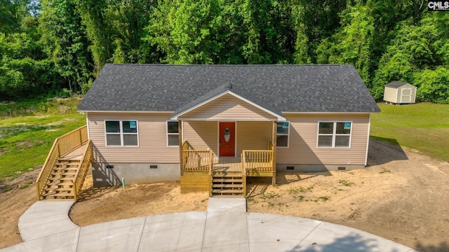 view of front of home featuring a storage shed