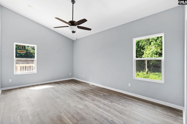 unfurnished room with wood-type flooring, lofted ceiling, and ceiling fan