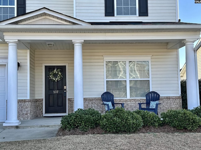 view of exterior entry featuring a porch