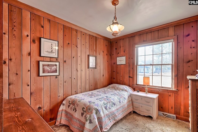 bedroom featuring wooden walls