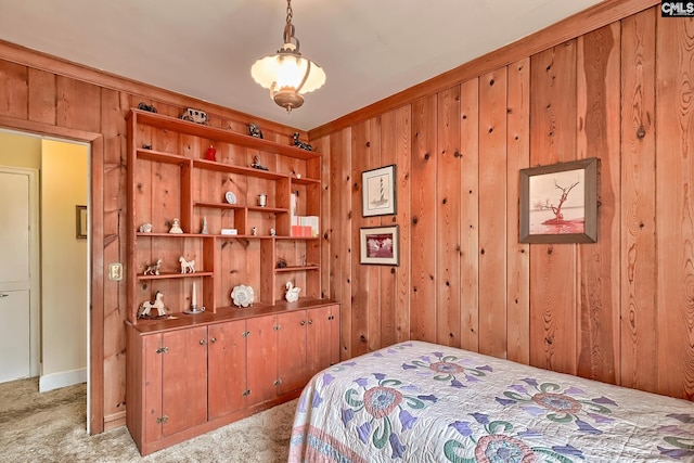 bedroom with light colored carpet and wood walls