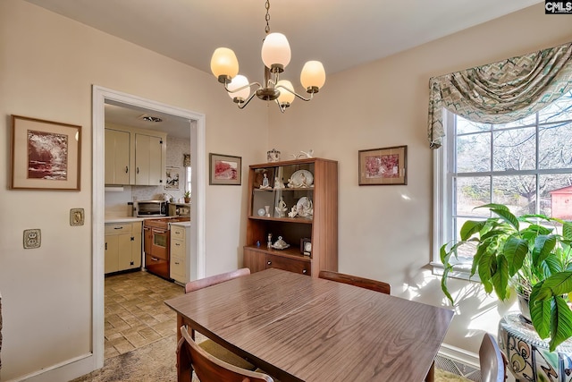 dining space with a chandelier