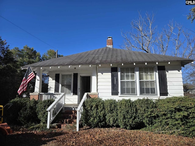 rear view of house with a porch