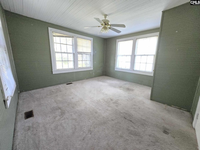 6500 White St, Kershaw, SC 29067 - carpeted empty room with ceiling fan and brick wall