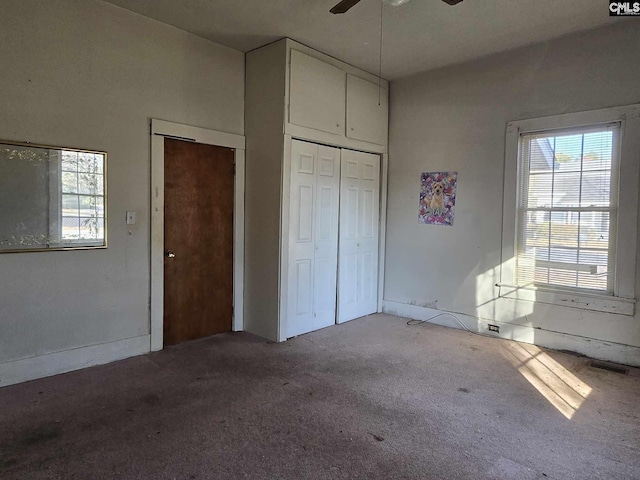 unfurnished bedroom with light colored carpet and a closet