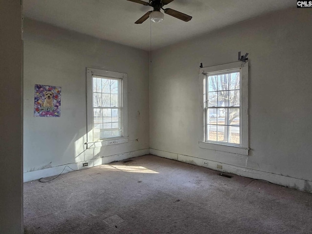 spare room with light colored carpet and ceiling fan