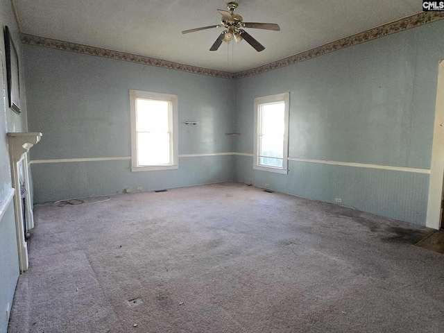 empty room featuring ceiling fan and carpet flooring