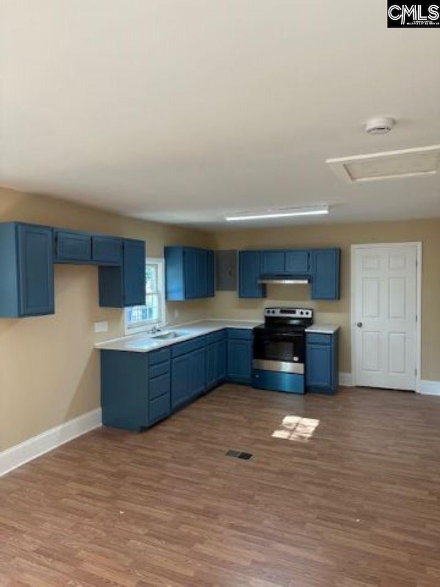 kitchen with blue cabinetry, hardwood / wood-style floors, sink, and stainless steel electric range