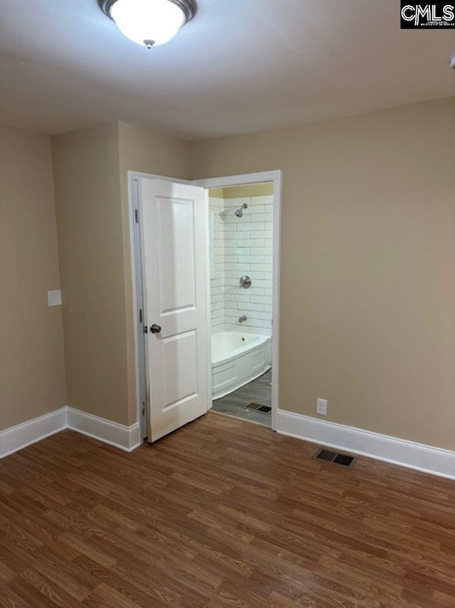 empty room with dark wood-type flooring