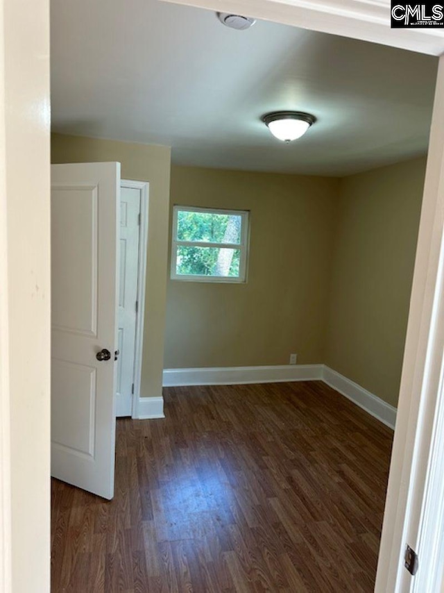 empty room with dark hardwood / wood-style floors